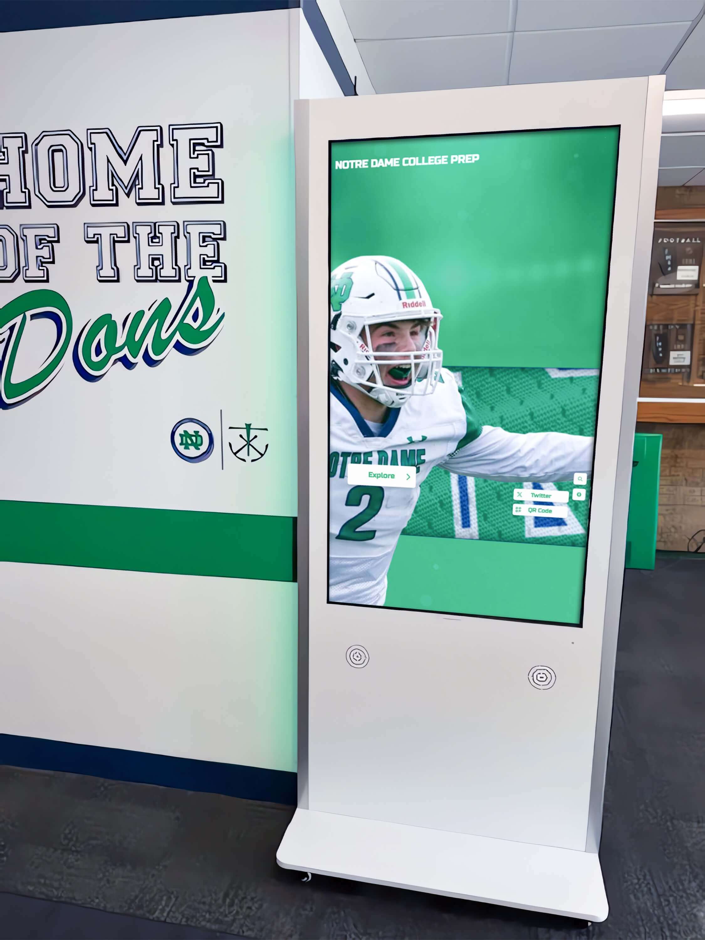 Interactive kiosk in hallway with football display Kiosk in facility lobby